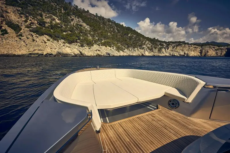  Yacht Photos Pics Luxurious 2023 Frauscher 1414 Demon yacht interior with scenic coastal backdrop.