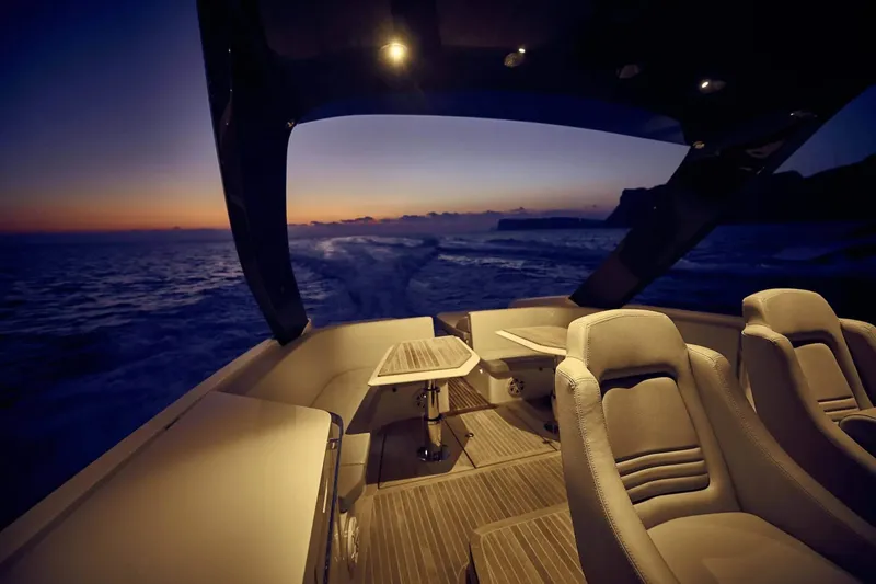  Yacht Photos Pics Luxury Frauscher 1414 Demon yacht interior at sunset, 2023 model, elegant seating and ocean view.