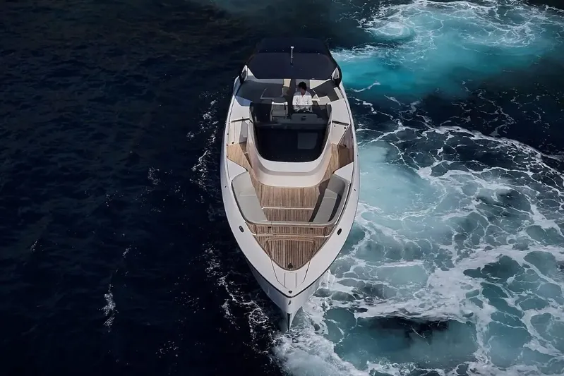  Yacht Photos Pics 2023 Frauscher 1414 Demon yacht cruising on open water, aerial view.