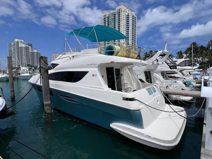  Yacht Photos Pics 2015 Silverton 43 Sport Bridge yacht docked at marina, under clear blue sky.