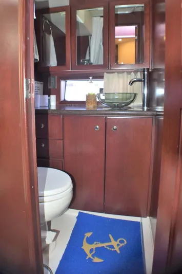  Yacht Photos Pics Luxurious bathroom in 2015 Silverton 43 Sport Bridge yacht with wood cabinetry and modern fixtures.