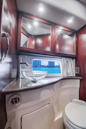  Yacht Photos Pics Luxurious bathroom in 2015 Silverton 43 Sport Bridge yacht with modern fixtures and wood cabinetry.