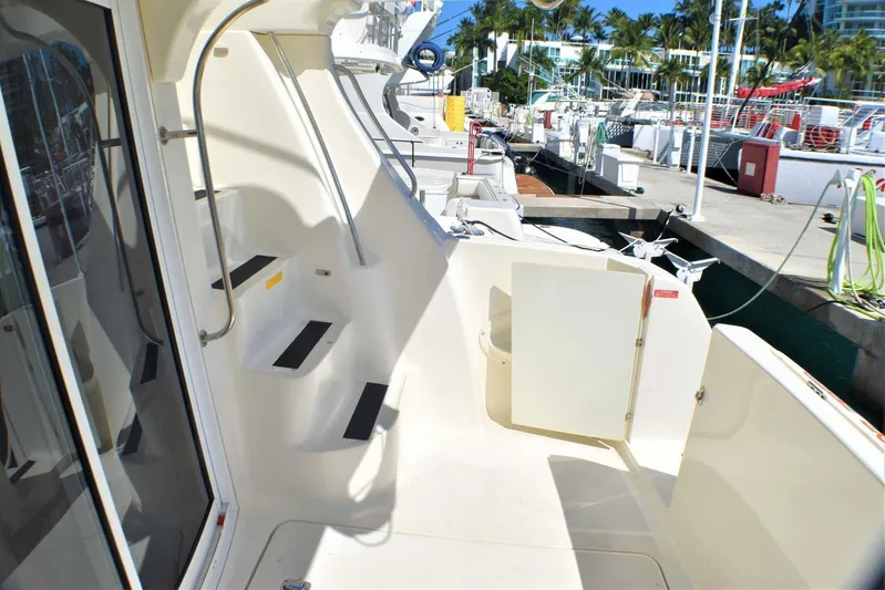  Yacht Photos Pics 2015 Silverton 43 Sport Bridge yacht docked, featuring sleek design and spacious deck area.