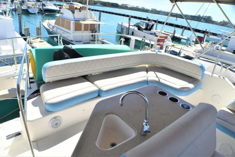  Yacht Photos Pics 2015 Silverton 43 Sport Bridge yacht with spacious seating and marina view.