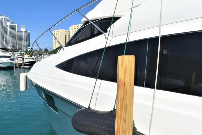  Yacht Photos Pics 2015 Silverton 43 Sport Bridge yacht docked in a marina with city skyline.