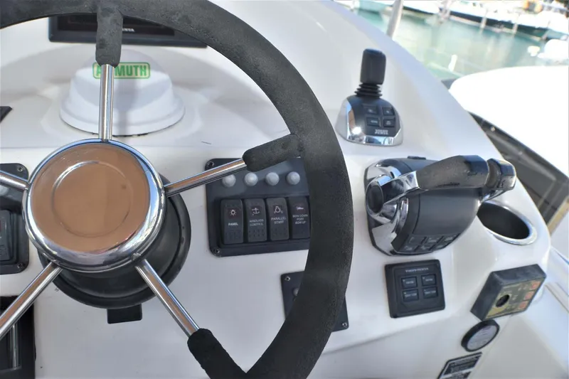  Yacht Photos Pics Helm of 2015 Silverton 43 Sport Bridge with steering wheel and controls.