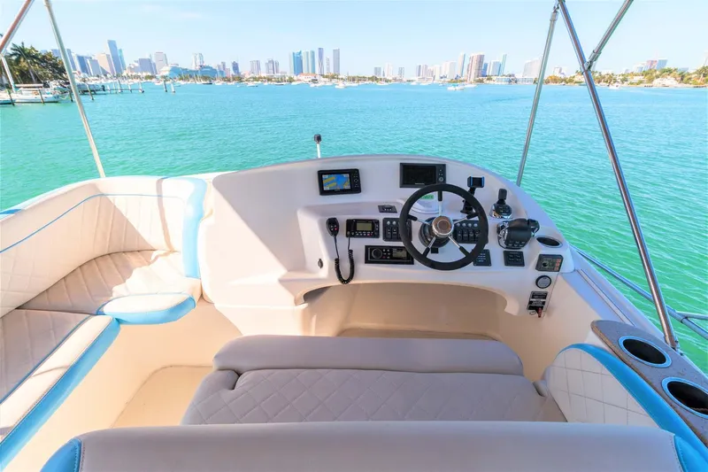  Yacht Photos Pics 2015 Silverton 43 Sport Bridge helm with city skyline and turquoise waters.