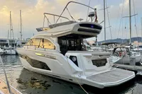 2017 Cranchi E 52 F yacht docked in marina at sunset.