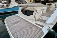 2017 Cranchi E 52 F yacht with teak deck and swim platform in marina.