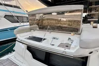 2017 Cranchi E 52 F yacht with outdoor kitchen and seating area at sunset.