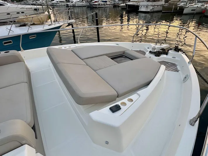  Yacht Photos Pics 2017 Cranchi E 52 F yacht with spacious deck and luxurious seating at marina.