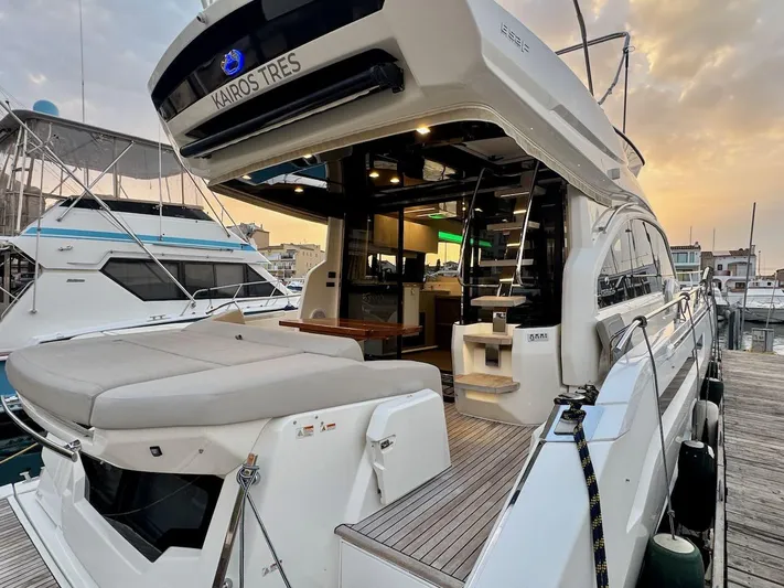  Yacht Photos Pics 2017 Cranchi E 52 F yacht docked at marina, showcasing luxurious deck and interior.