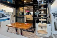 2017 Cranchi E 52 F yacht interior with wooden table and staircase.
