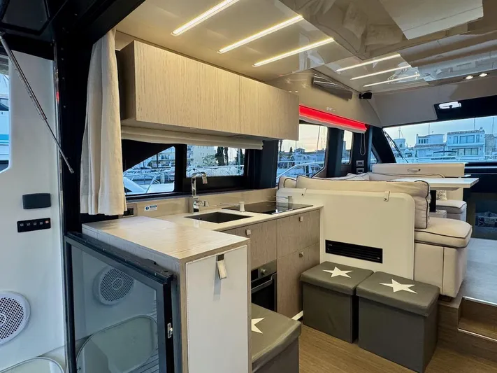  Yacht Photos Pics Luxurious interior of 2017 Cranchi E 52 F yacht with modern kitchen and seating area.