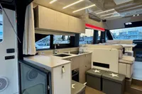 Luxurious interior of 2017 Cranchi E 52 F yacht with modern kitchen and seating area.