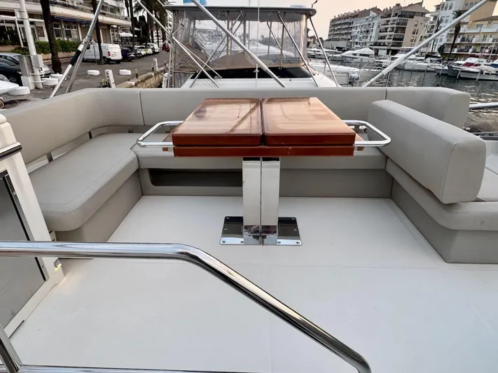  Yacht Photos Pics Luxurious 2017 Cranchi E 52 F yacht with elegant outdoor seating and table.