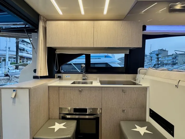  Yacht Photos Pics Modern kitchen interior of 2017 Cranchi E 52 F yacht with sleek cabinetry and appliances.