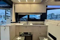 Modern kitchen interior of 2017 Cranchi E 52 F yacht with sleek cabinetry and appliances.