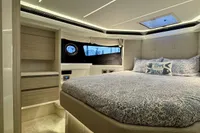 Luxurious bedroom interior of 2017 Cranchi E 52 F yacht with elegant bedding and modern design.