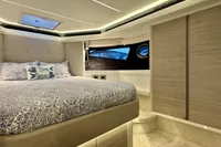 Luxurious interior of 2017 Cranchi E 52 F yacht with elegant bedding and modern design.