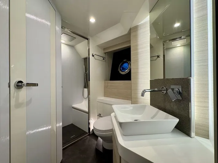  Yacht Photos Pics Luxurious bathroom interior of 2017 Cranchi E 52 F yacht with modern fixtures.