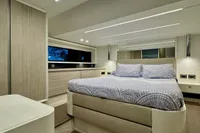 Luxurious bedroom interior of 2017 Cranchi E 52 F yacht with modern design.