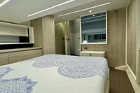 Luxurious bedroom interior of 2017 Cranchi E 52 F yacht with elegant decor.