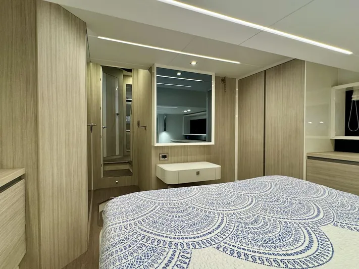  Yacht Photos Pics Luxurious 2017 Cranchi E 52 F yacht bedroom with modern decor and elegant bedding.