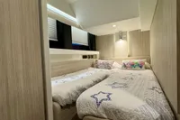 2017 Cranchi E 52 F yacht cabin with twin beds and modern decor.