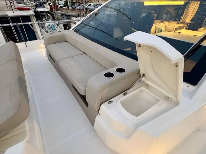  Yacht Photos Pics Luxurious seating area on 2017 Cranchi E 52 F yacht with built-in cup holders.