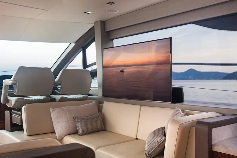 M/y Lady K Yacht Photos Pics Luxurious interior of 2018 Sunseeker Manhattan 52 yacht with plush seating and scenic view.