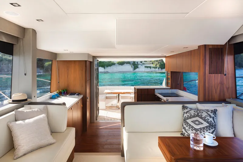 M/y Lady K Yacht Photos Pics Luxurious interior of 2018 Sunseeker Manhattan 52 yacht with elegant furnishings and scenic ocean view.