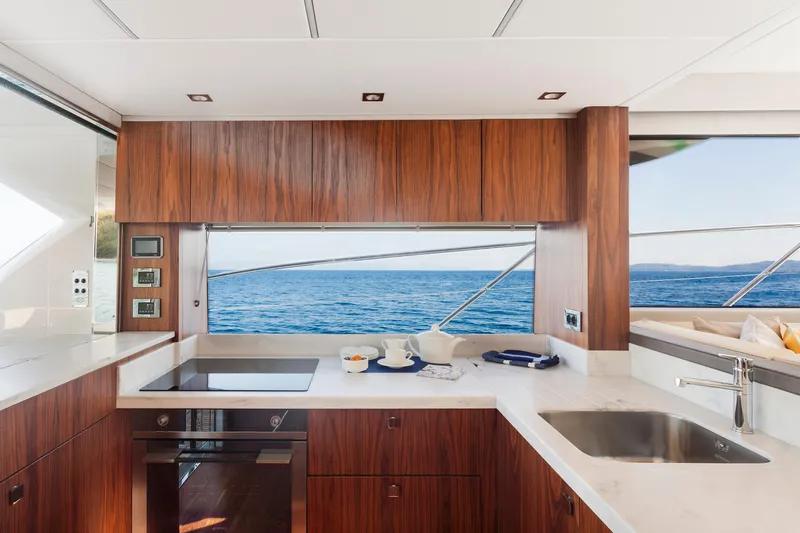 M/y Lady K Yacht Photos Pics Luxurious kitchen interior of 2018 Sunseeker Manhattan 52 yacht with ocean view.