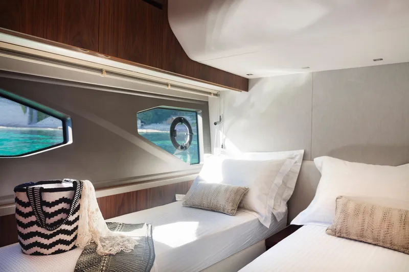 M/y Lady K Yacht Photos Pics Luxurious cabin interior of 2018 Sunseeker Manhattan 52 yacht with twin beds and window view.