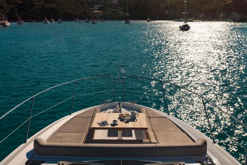 M/y Lady K Yacht Photos Pics Luxurious 2018 Sunseeker Manhattan 52 yacht on sparkling blue water, with elegant deck seating.