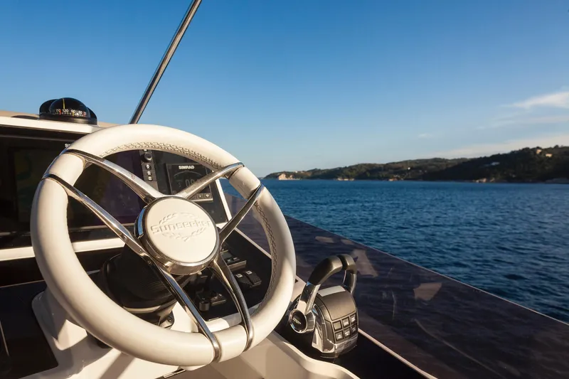 M/y Lady K Yacht Photos Pics Steering wheel of 2018 Sunseeker Manhattan 52 yacht with scenic ocean view.