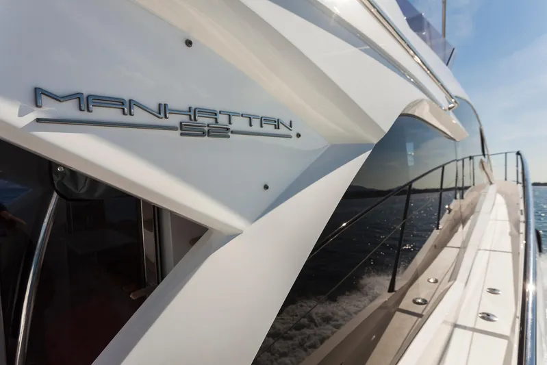 M/y Lady K Yacht Photos Pics 2018 Sunseeker Manhattan 52 yacht cruising on open water, showcasing sleek design and luxury.