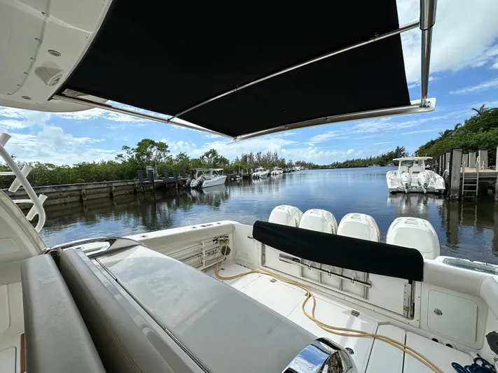  Yacht Photos Pics Boston Whaler 420 Outrage 2020, docked with scenic waterway view.