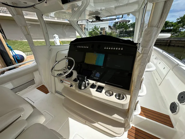  Yacht Photos Pics 2020 Boston Whaler 420 Outrage helm with advanced navigation system and luxurious seating.