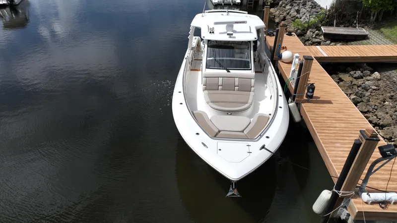  Yacht Photos Pics Boston Whaler 420 Outrage 2020 docked in calm waters, aerial view.