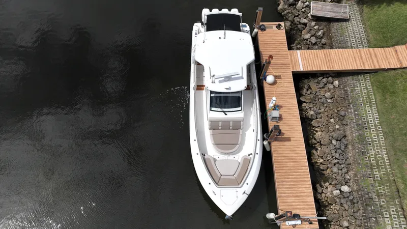  Yacht Photos Pics Aerial view of 2020 Boston Whaler 420 Outrage docked at a wooden pier.