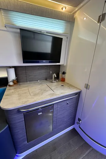  Yacht Photos Pics 2020 Boston Whaler 420 Outrage interior kitchen with modern appliances and sleek design.