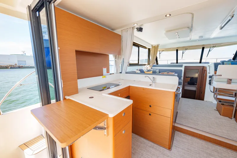 Carolina Blues Yacht Photos Pics 2025 Beneteau Swift Trawler 41 Fly interior with modern kitchen and seating area.