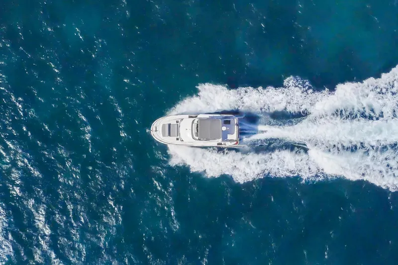 Carolina Blues Yacht Photos Pics Aerial view of 2025 Beneteau Swift Trawler 41 Fly cruising on open water.