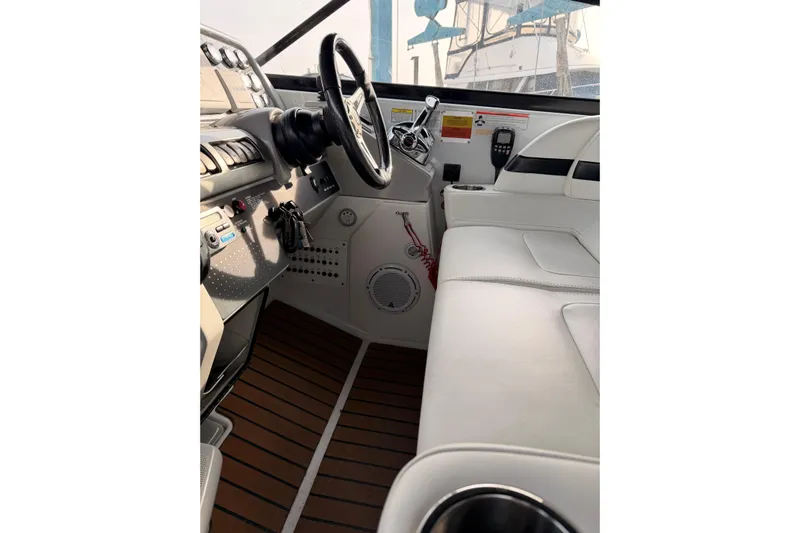  Yacht Photos Pics 2009 Formula 350 Sun Sport boat interior with steering wheel and white seating.