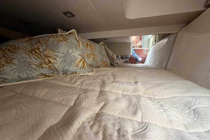  Yacht Photos Pics Cozy cabin interior of 2009 Formula 350 Sun Sport with tropical-themed bedding.