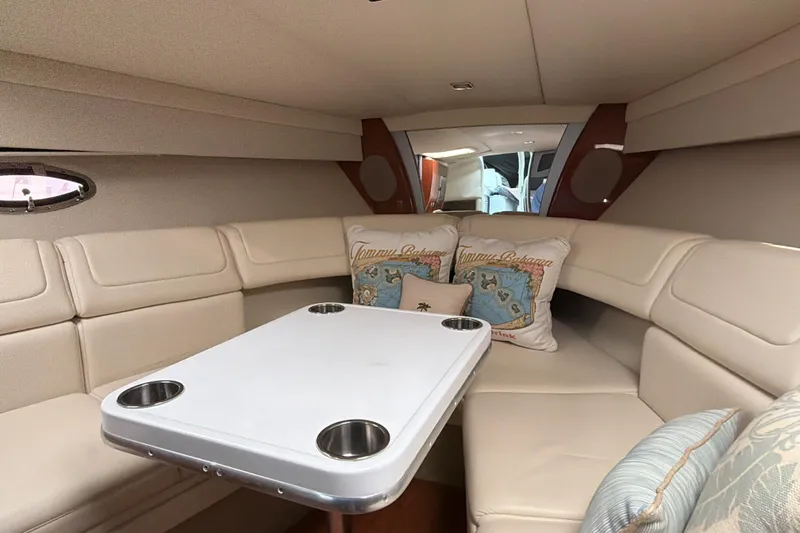  Yacht Photos Pics 2009 Formula 350 Sun Sport cabin with beige seating and table, featuring decorative pillows.