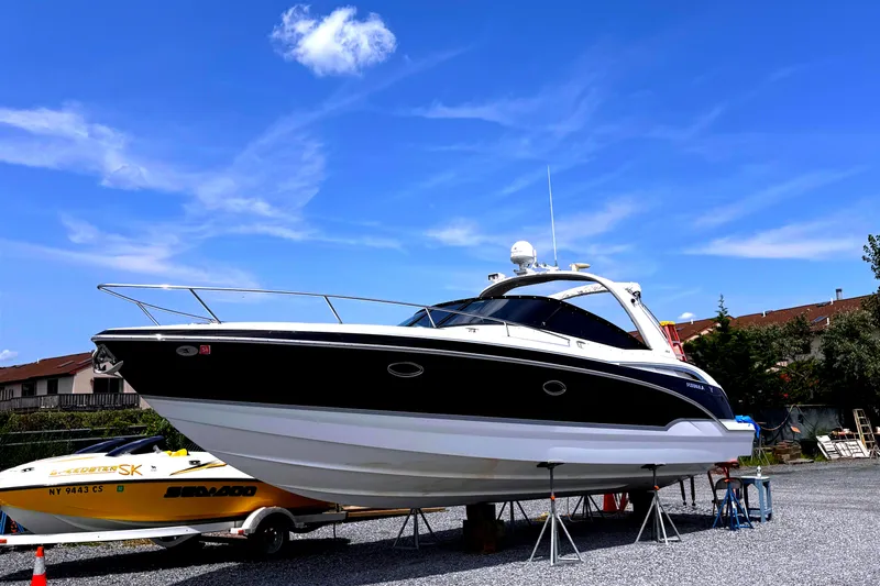  Yacht Photos Pics 2009 Formula 350ss boat on stands, clear sky background.