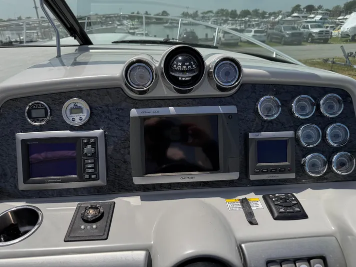  Yacht Photos Pics Dashboard of a 2009 Formula 350ss boat with navigation instruments and controls.