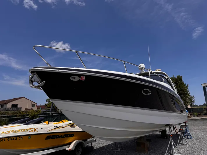  Yacht Photos Pics 2009 Formula 350ss boat on stands under a clear blue sky.